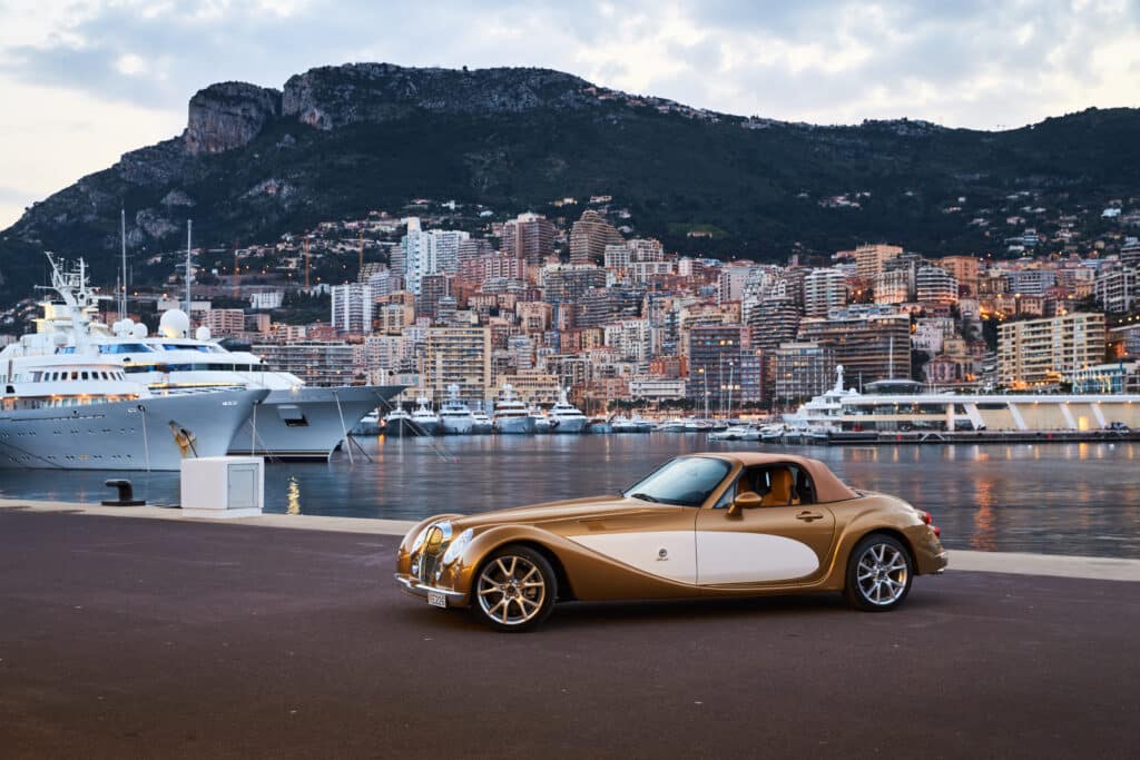 Car in Monte-Carlo port with yachts in the background